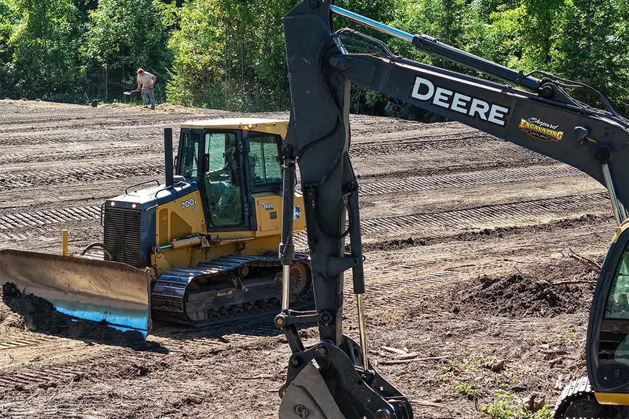 A John Deere excavator and dozer on a site-prep job in northern Minnesota