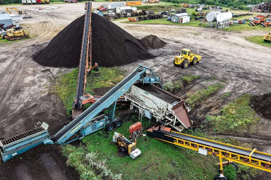A conveyor stacking screened material