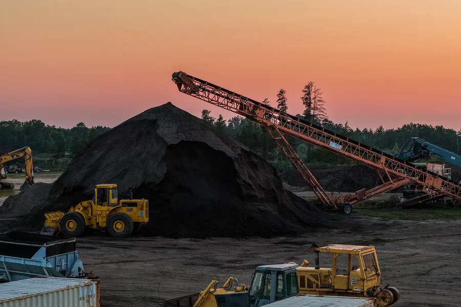 A screening plant working at sunset