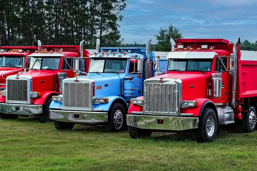 Storlie Construction Peterbilt dump trucks in a row